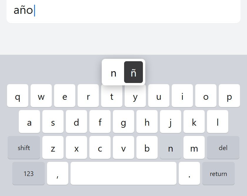 iPhone keyboard with the hold menu open, ñ selected, while typing año