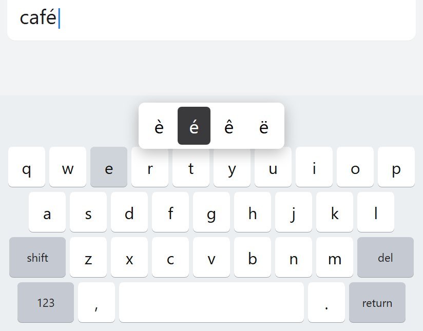 Android keyboard with the hold menu open, é selected, while typing café