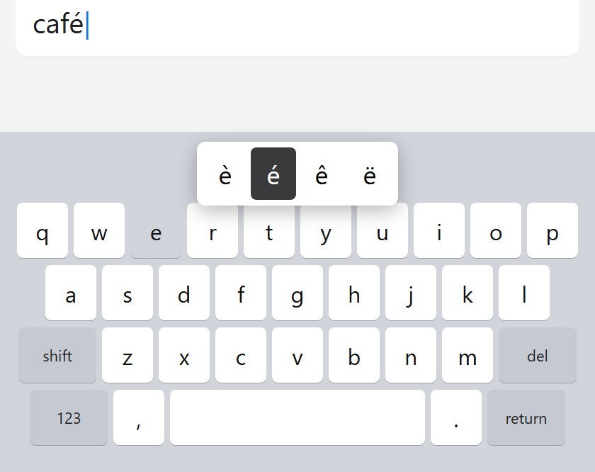 iPhone keyboard with the hold menu open, é selected, while typing café